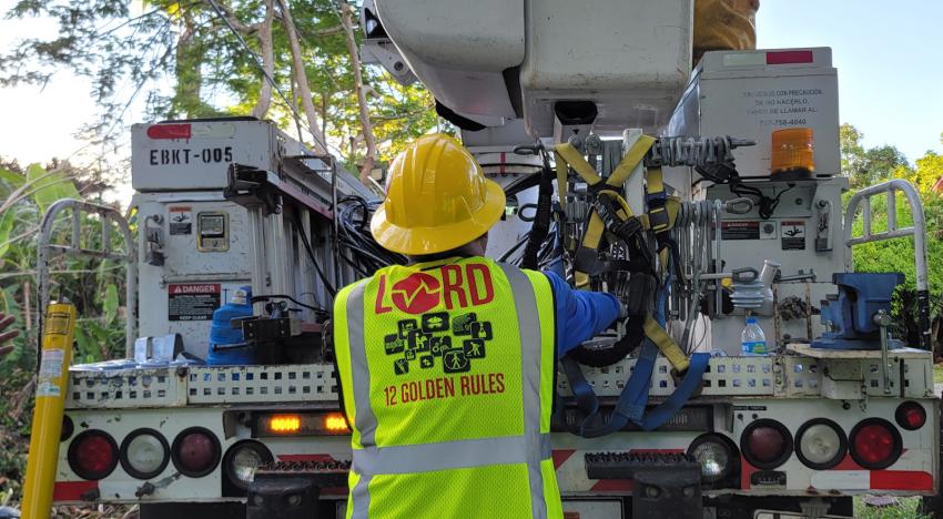 Worker getting equipment from utility truck