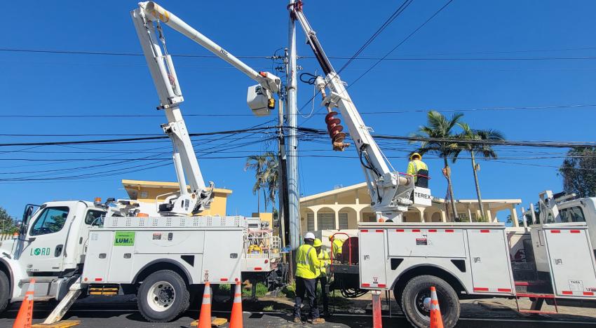 Bucket trucks repairing overhead cables