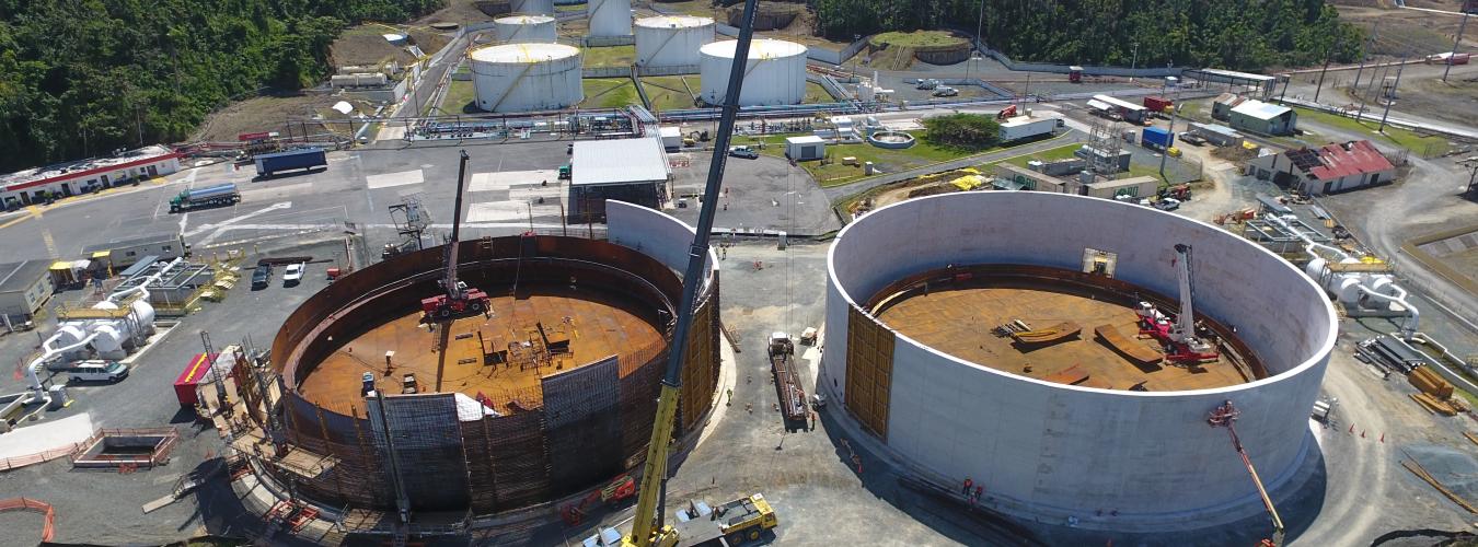 Aerial view of large holding tanks under construction